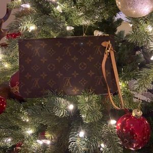 New Louis Vuitton wristlet  size L 9.75” x 6 H x 13.4 “handle .